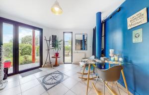 a dining room with a blue wall and a table and chairs at STUDIO 88 in Sainte-Adresse