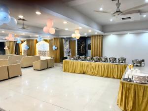 a banquet hall with tables and chairs and balloons at Evesta Micasa in Haridwār