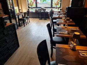 a row of tables and chairs in a restaurant at Gasthaus Paula in Üdersdorf +7 photos