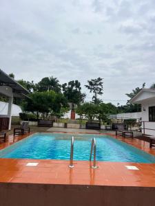 a swimming pool with blue water in a building at Resort Ideal Forest in São Tomé +21 photos