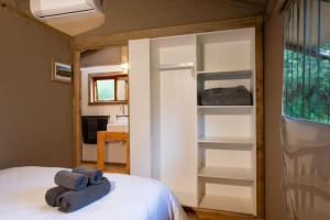 a bedroom with a bed with towels on it at AfriCamps at Mackers  +32 photos