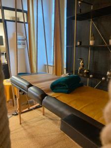 a bed on a swing in a room at SUITE KASSIOPEE, romantisme, balnéo, sauna in Quimperlé