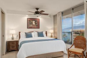 a bedroom with a bed and a large window at Mana Kai 611C in Wailea