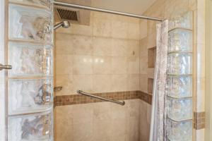 a bathroom with a shower with a shower curtain at Mana Kai 611C in Wailea +31 photos