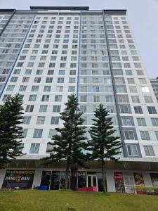 a large building with two trees in front of it at Escapade in Tagaytay by JV in Kaybagal