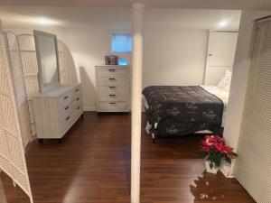 a bedroom with a bed and a dresser and a dresser at Cozy Studio in Elmont