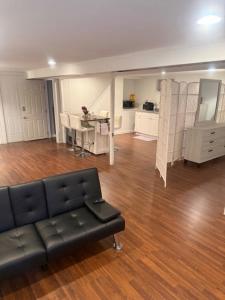 a living room with a couch and a table at Cozy Studio in Elmont