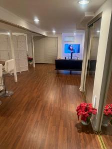 an empty room with a desk and flowers in it at Cozy Studio in Elmont