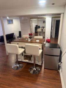 an office with a desk and two chairs and a table at Cozy Studio in Elmont +3 photos