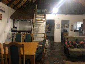 a dining room and kitchen with a table and a staircase at Best view family loft in Oranjeville