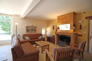 a living room with a couch and a fireplace at La métairie in Isle