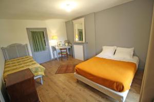 a bedroom with a bed and a table in it at La métairie in Isle +37 photos