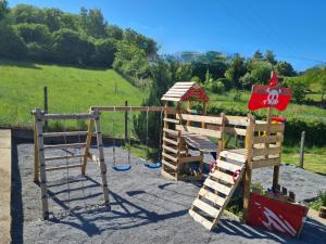 a playground with a slide and a swing at Gasthaus Paula in Üdersdorf