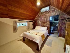 a bedroom with a bed in a room at Castelar da Alvorada in Vale do Capao +77 photos