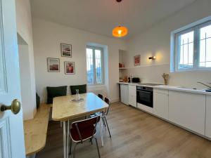 a kitchen and dining room with a table and a dining room at Chez MARIE in Valence