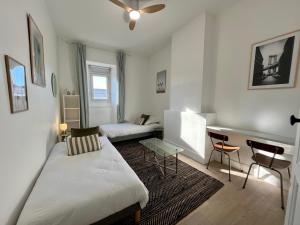 a room with a bed and a table and a couch at Chez MARIE in Valence