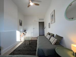 a living room with a couch and a table at Chez MARIE in Valence
