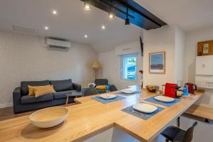 a living room with a table and a couch at L'Appart de Rohan - Centre de Pontivy in Pontivy