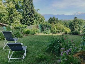 two chairs sitting in the grass in a garden at Gîte la Planta de Cossey 2 in Claix +10 photos