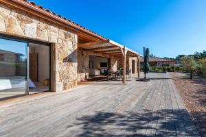 an outdoor deck of a stone house with a patio at Villa U Capu - Piscine Privée in Lecci