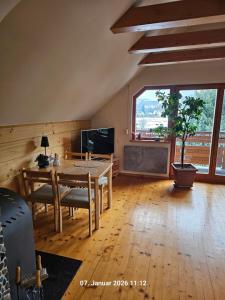 a living room with a table and a large window at Ferienhaus Lipowa in Lipowa