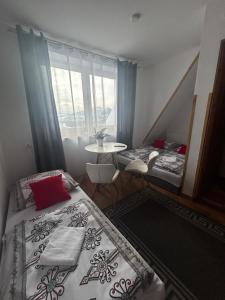 a room with two beds and a table and a window at Na Górce W Białym Dunajcu in Biały Dunajec +21 photos