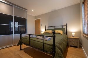 a bedroom with a bed and a glass wall at The Old Pitman's house in Ollerton