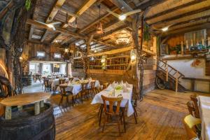 a restaurant with tables and chairs in a room with wooden floors at Hörners Landgasthof in Geislingen an der Steige