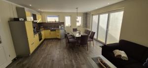 a kitchen and living room with a table and chairs at Ferienhaus Seeschwalbe in Fehmarn