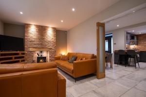 a living room with a couch and a fireplace at The Old Pitman's house in Ollerton