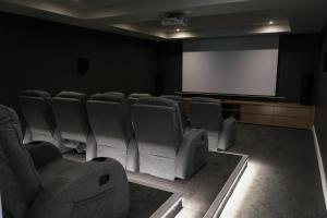 a conference room with chairs and a projection screen at Parrotfish Room in Ballito +23 photos