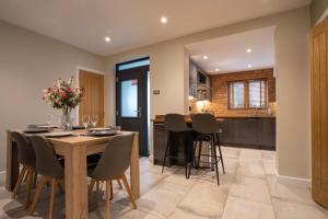 a kitchen and dining room with a wooden table and chairs at The Old Pitman's house in Ollerton