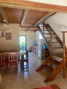 a kitchen and dining room with a wooden staircase in a house at Altos de Artalaz in Colón