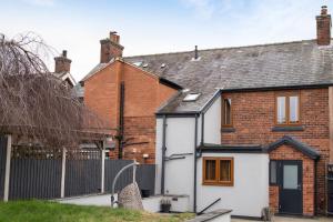 a white house with a black roof at The Old Pitman's house in Ollerton