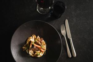 a plate of food on a table with a fork and knife at MyPARADIES in Solda +50 photos