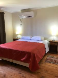 a bedroom with a large bed with a red blanket at Altos de Artalaz in Colón +64 photos