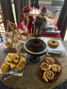a table with a cake and a plate of food at Pousada Vila Italia - Porto da Dunas in Aquiraz