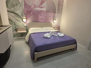 a bedroom with a bed with two stuffed animals on it at Flag in Torre del Greco
