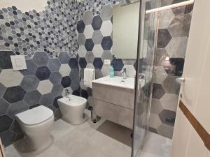 a bathroom with a toilet and a sink and a shower at Flag in Torre del Greco