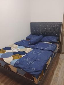 a bed with blue sheets and blue pillows on it at Widodaren homestay singel bed in Ngadisari