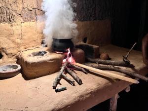 a stove with a pot with smoke coming out of it at Brooklyne Jungle Nest in Udawalawe +18 photos