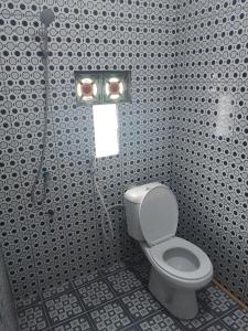 a bathroom with a toilet and a shower stall at Widodaren homestay singel bed in Ngadisari