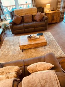 a living room with a couch and a coffee table at Looby Lodge in Tattershall