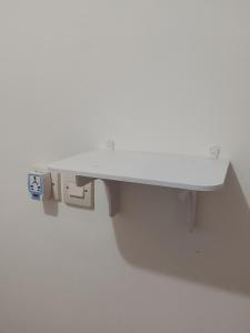 a white desk attached to a wall at Widodaren homestay singel bed in Ngadisari
