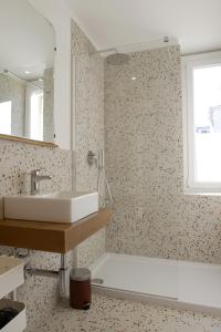 a bathroom with a sink and a bath tub at LA FORESTERIA Case a Varese in Varese