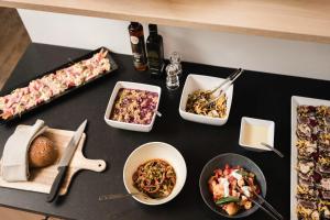 a table with many different dishes of food on it at MyPARADIES in Solda