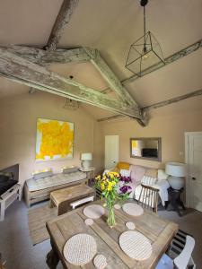 a living room with a table and a couch at Little Plas in Crickhowell
