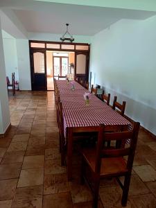 a dining room with a long table and chairs at Belvedere GreșuLepșa in Greşu