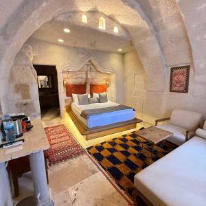 a bedroom with a bed in a stone room at Local Cave House in Göreme +174 photos