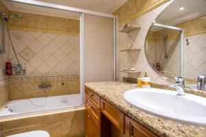 a bathroom with a sink and a tub and a shower at Christine Beachside Villa Pefkos in Pefki +21 photos